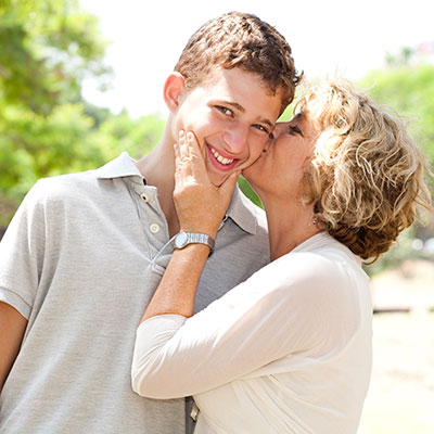 Image of Portrait of a happy senior woman kissing grandson